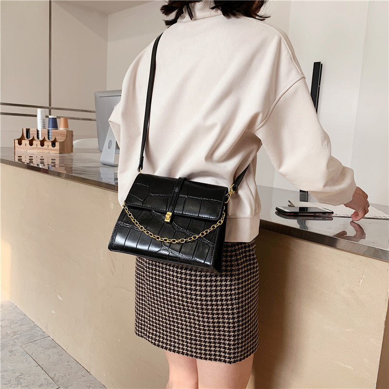 Small square shoulder bag lock closure close-up
