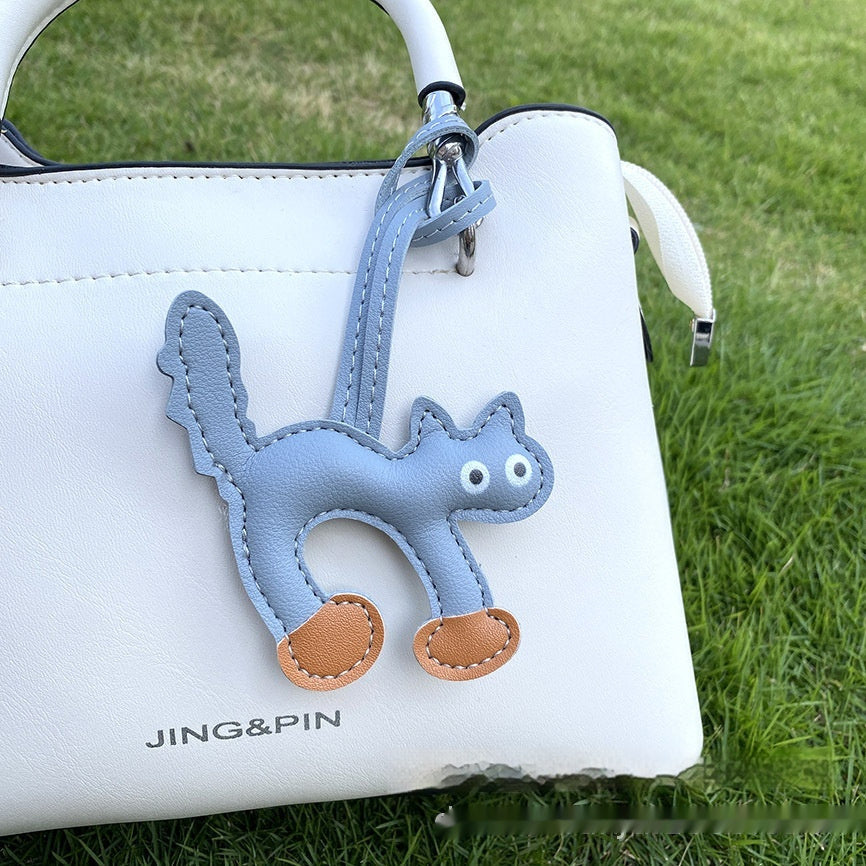 Cat bag charm styled with handbag outfit